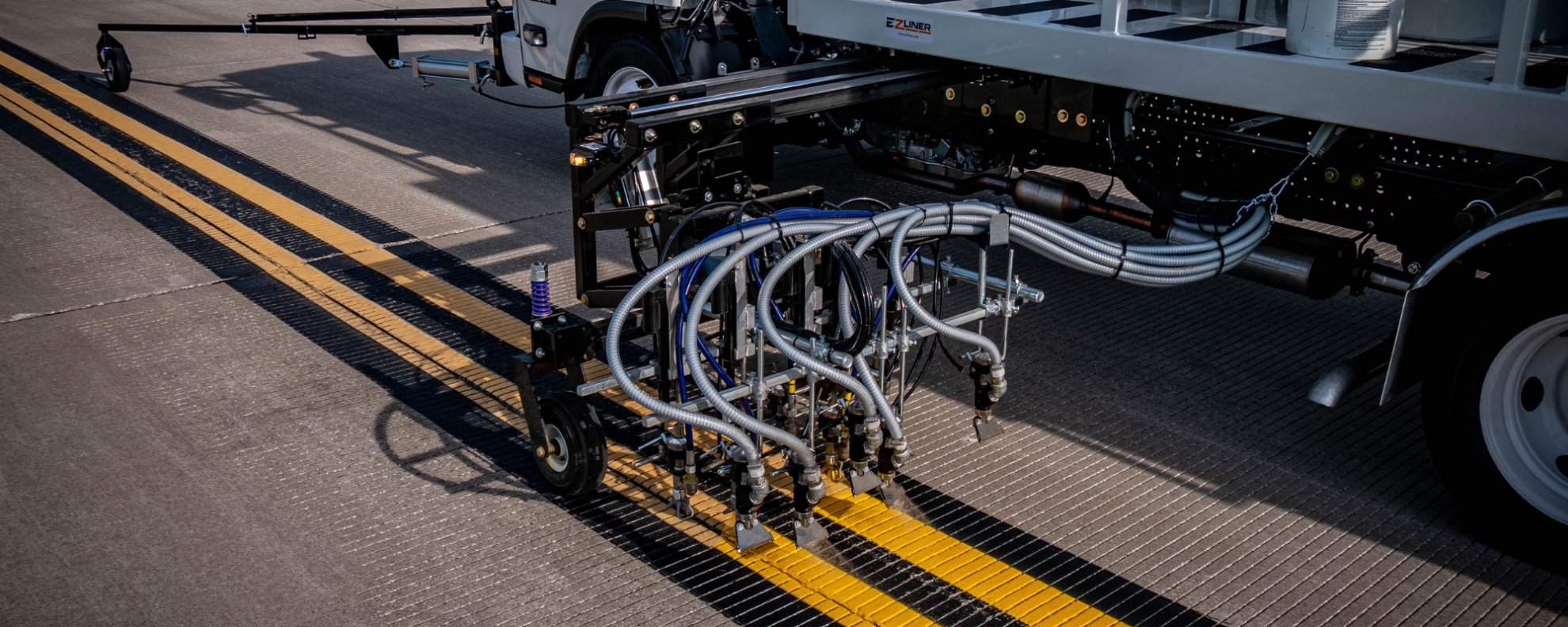 A truck spraying paint on the road